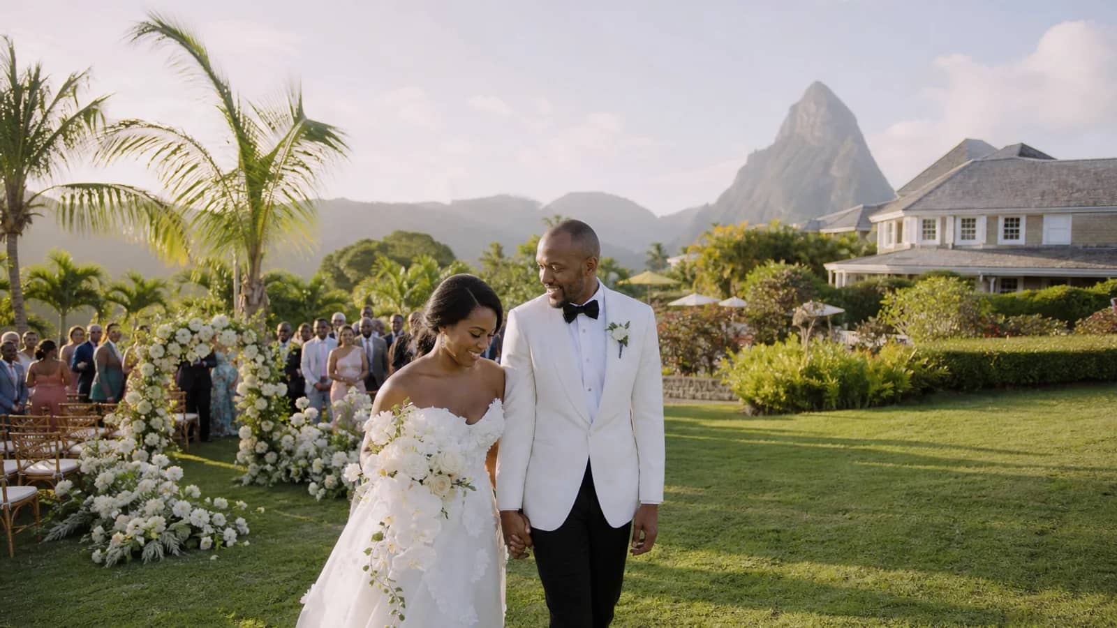 A newly married couple beside a tropical garden ceremony in Saint Lucia.